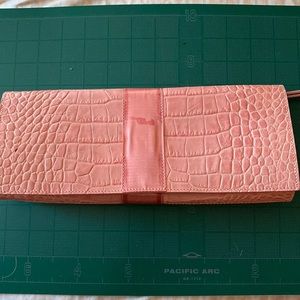 Harold’s pink leather croc embossed wristlet/clutch